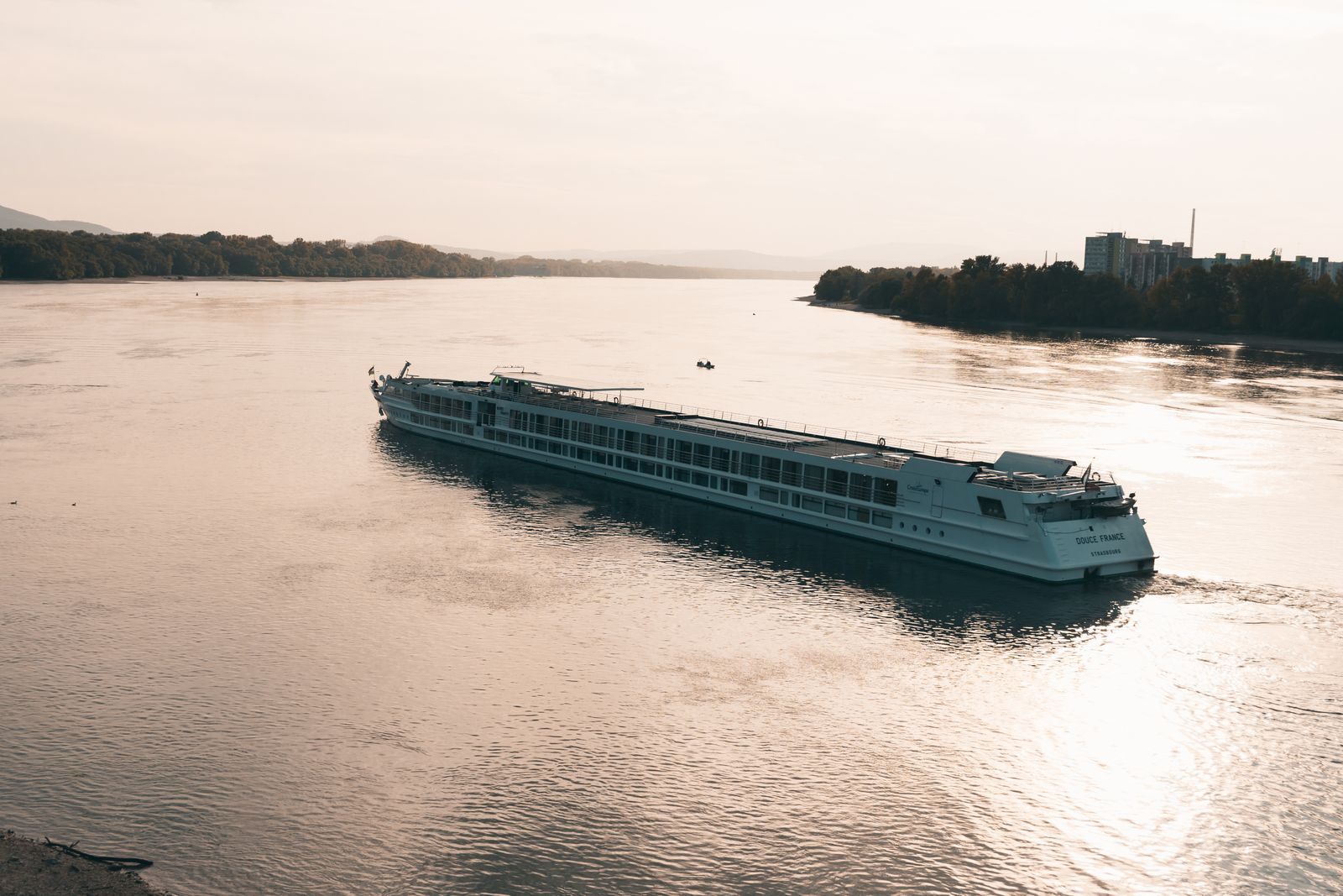 River cruise ship gliding along the Danube near Esztergom at sunset, the setting for luxurious river cruises in Europe