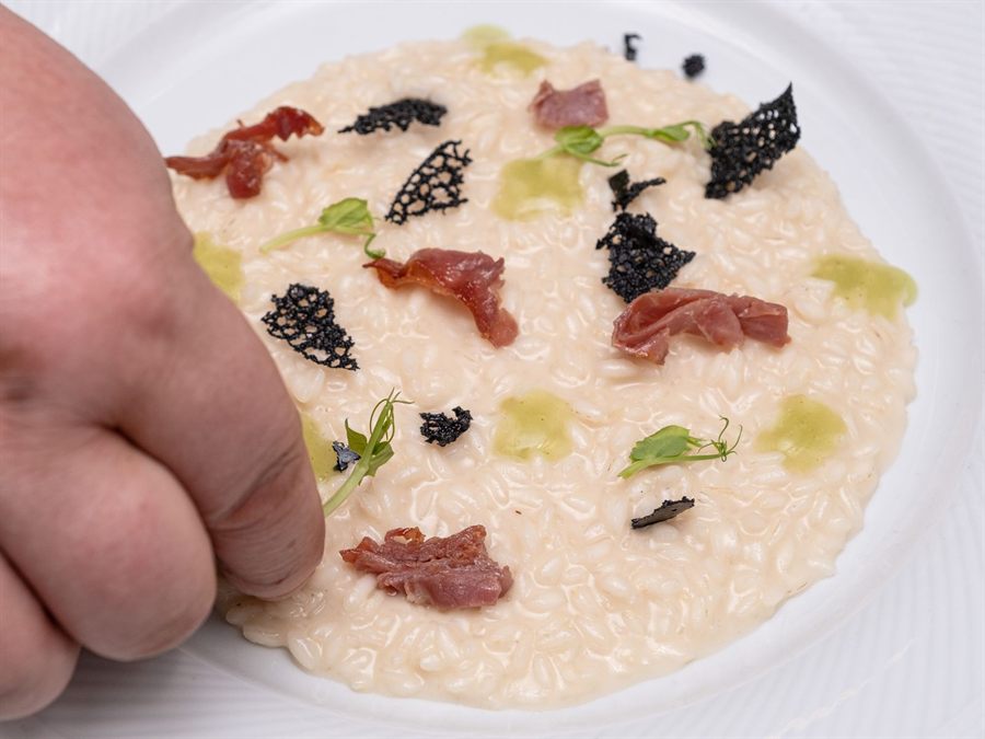 Chef finishing a truffle risotto